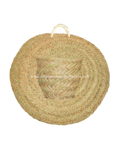 Cache-pot avec un pot sur un tapis ronde en sparte naturel